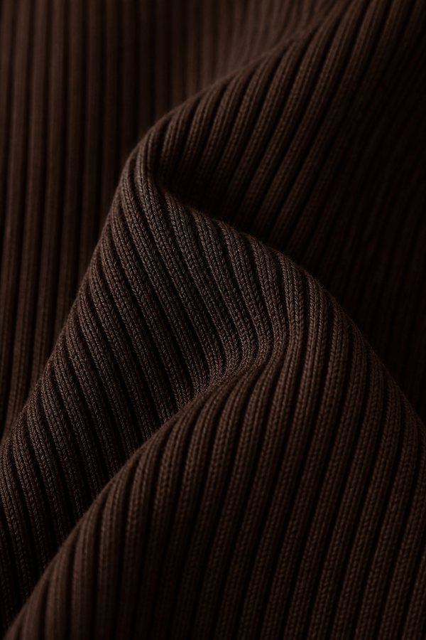 Macro detail of a warm oat performance rib knit