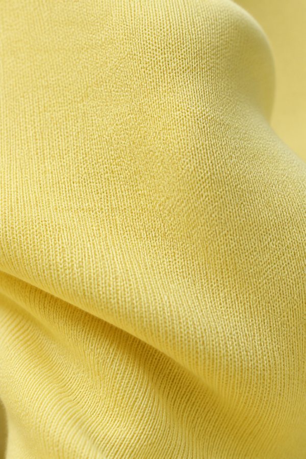 Macro detail of a pale-yellow seamless sculpt knit